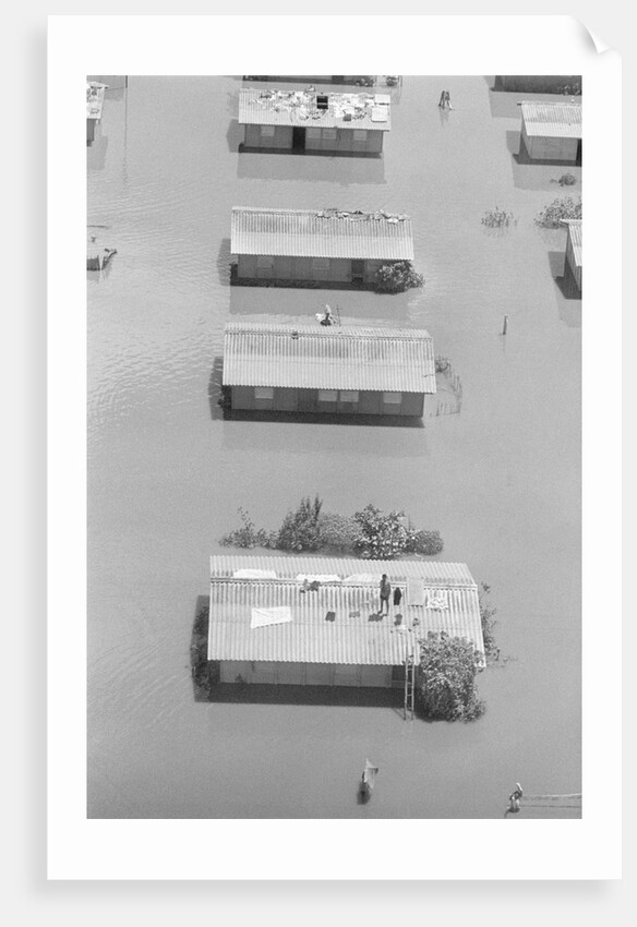Aerial View Of Man On Roof In Flood by Anonymous