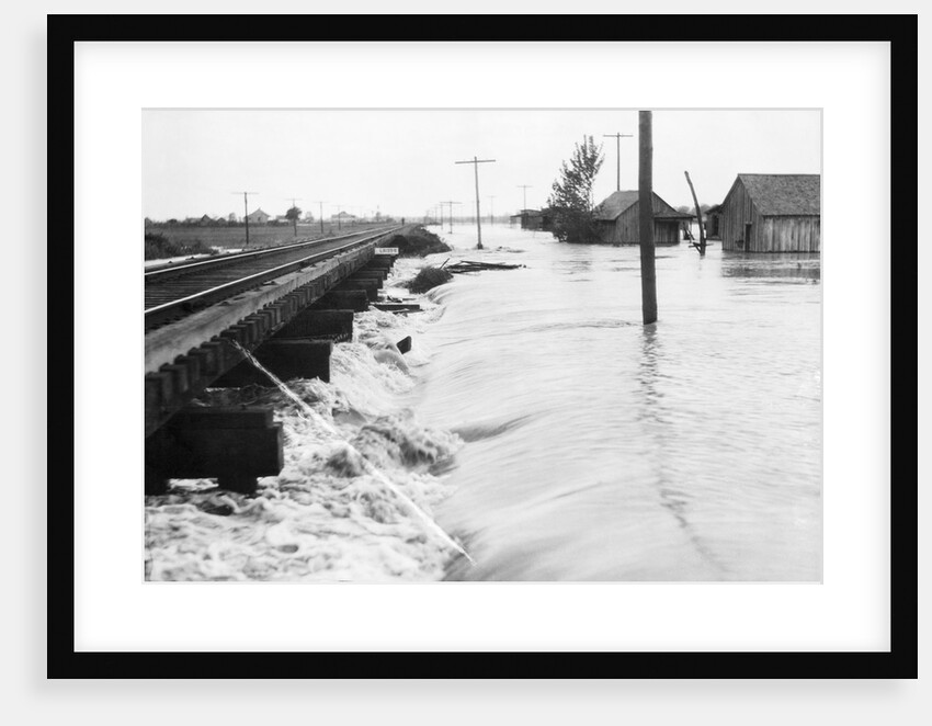 River Flood Waters Wash Around Rr Trestl by Anonymous