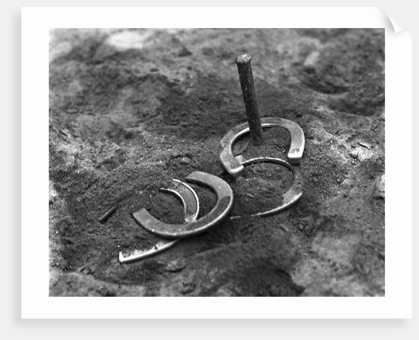 Horseshoes Around Pole by Anonymous