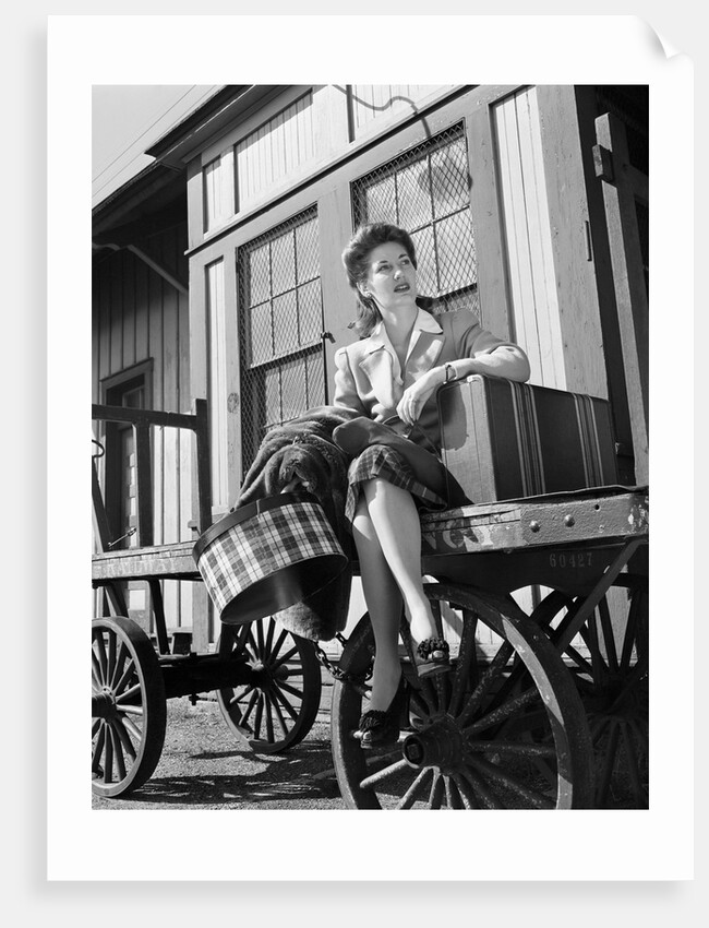 Woman Sitting on Luggage Trolley by Anonymous