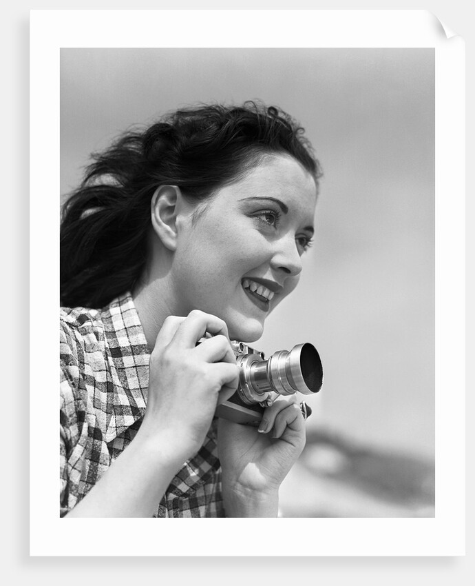 Woman Smiles as She Holds Camera by Anonymous