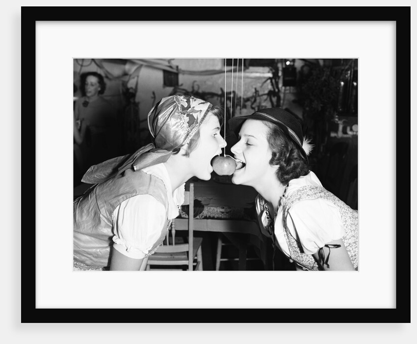 Girls Biting into Hanging Apple by Anonymous