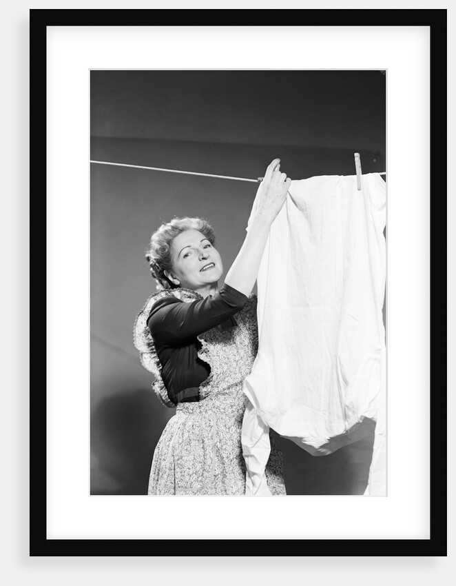 Woman Hanging Laundry by Anonymous