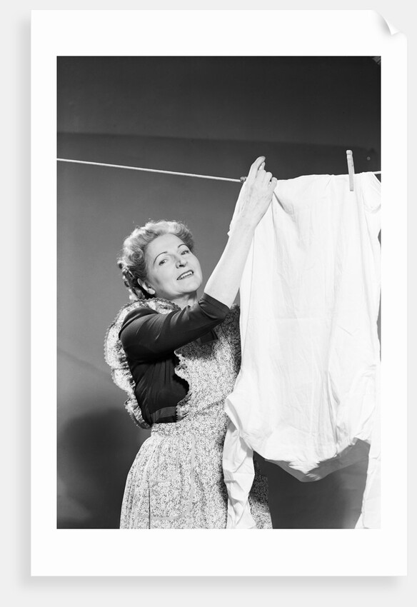 Woman Hanging Laundry by Anonymous