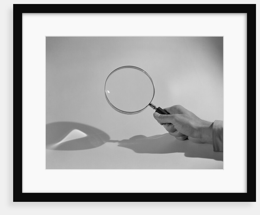 Hand Holding a Magnifying Glass by Anonymous