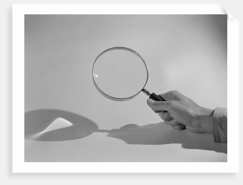 Hand Holding a Magnifying Glass by Anonymous