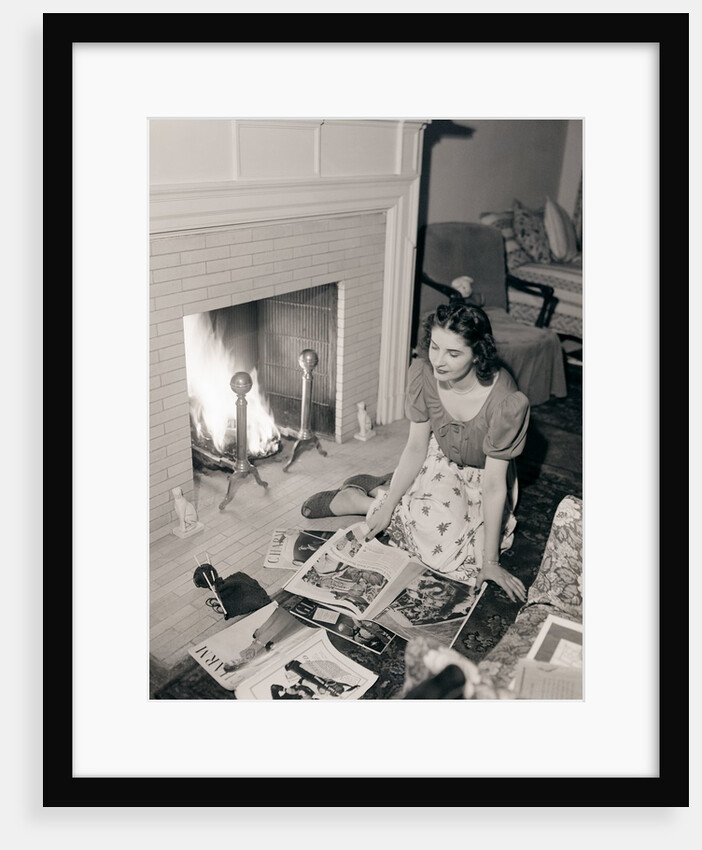 Young Woman Looking at Magazines by Anonymous