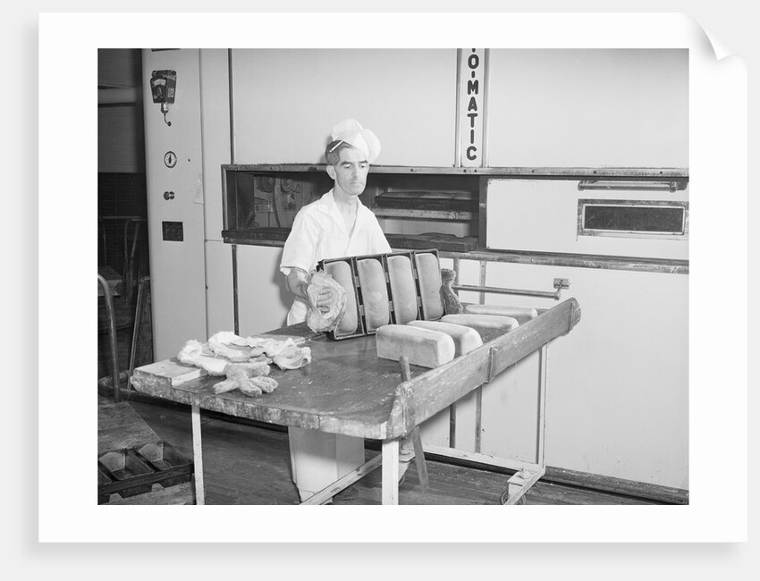 Man Taking Bread Loaves from Oven by Anonymous