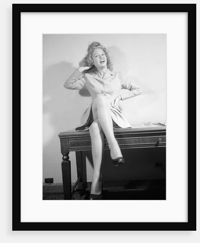 Woman Seated on Desk with Legs Crossed by Anonymous