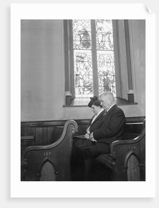 Couple Seated in Church Pew by Anonymous