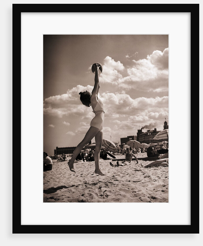 Young Woman Playing Ball On Beach by Anonymous