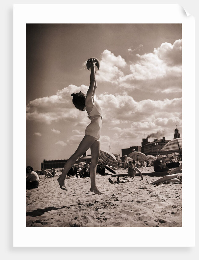 Young Woman Playing Ball On Beach by Anonymous
