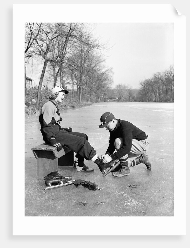 Man Putting on Woman's Ice Skates by Anonymous
