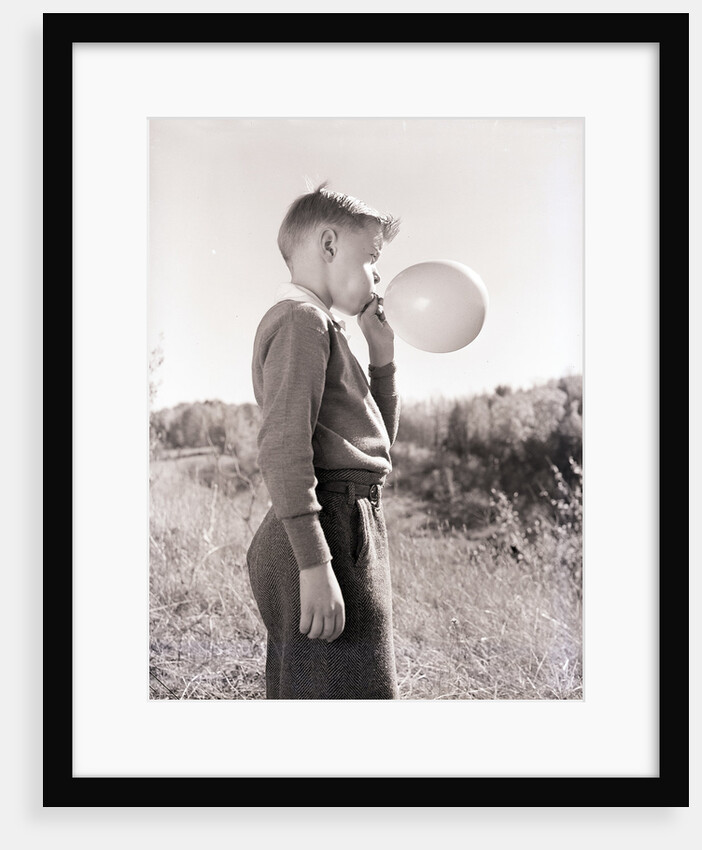 Boy Blowing a Balloon by Anonymous
