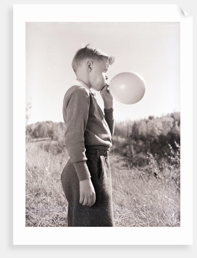 Boy Blowing a Balloon by Anonymous