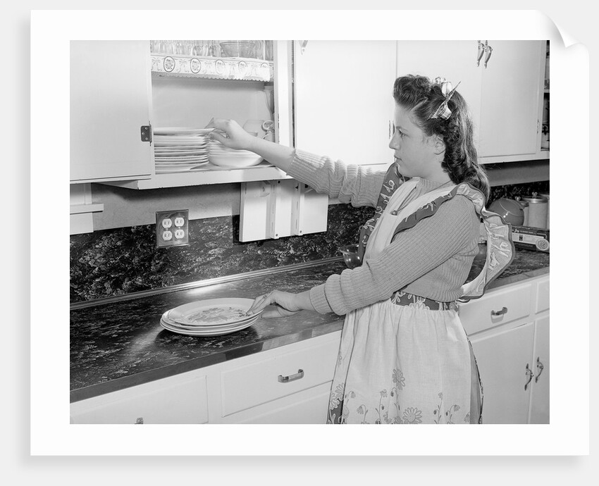 Woman Putting Dishes In Cabinet by Anonymous