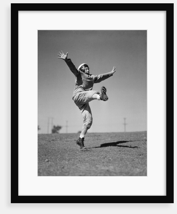 Boy Kicking a Football by Anonymous