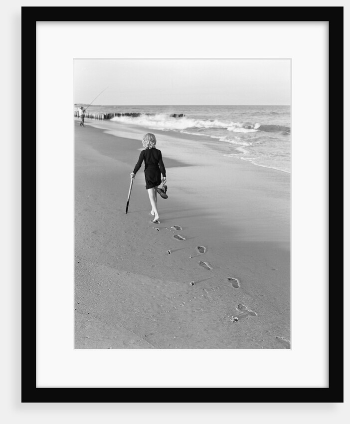 Woman Walking on Beach Leaving Footprints by Anonymous