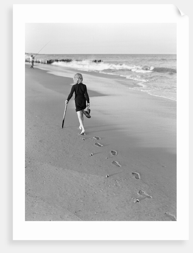 Woman Walking on Beach Leaving Footprints by Anonymous