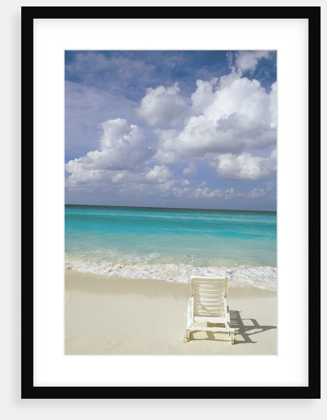 Lone Lounge Chair on Sandy Beach by Anonymous