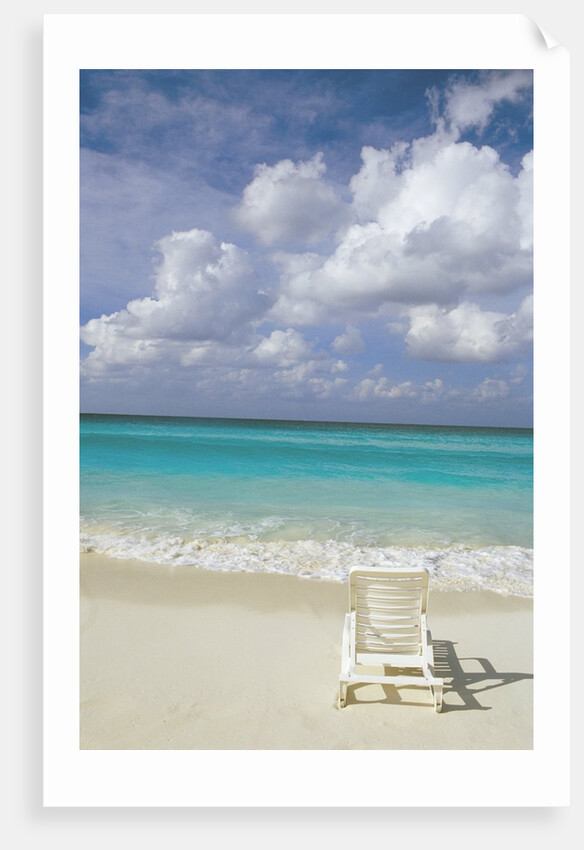 Lone Lounge Chair on Sandy Beach by Anonymous