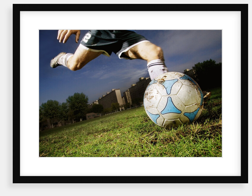 Soccer Player Kicking Ball by Anonymous