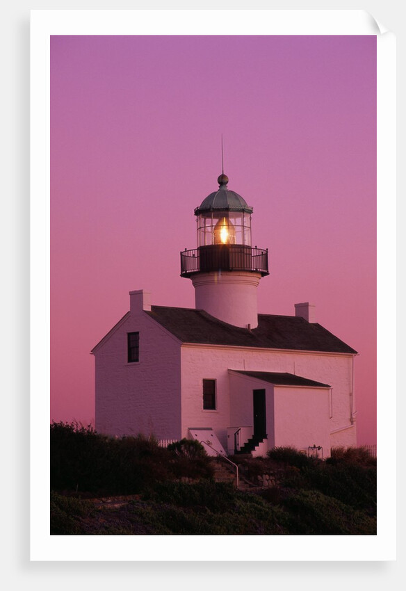 Lighthouse Against a Pink Sky at Twilight by Anonymous