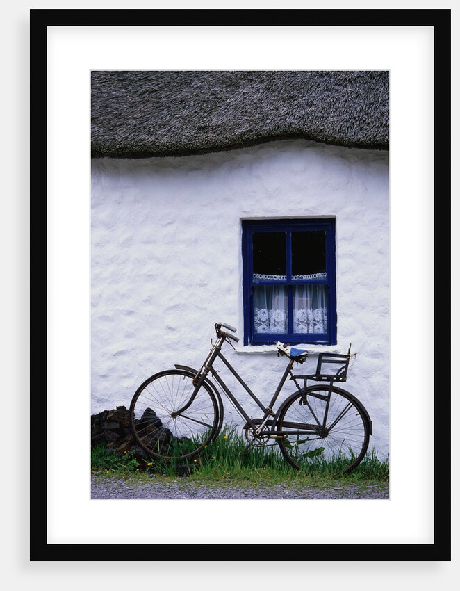 Bicycle Leaning Against a Thatch-Roof Cottage by Anonymous