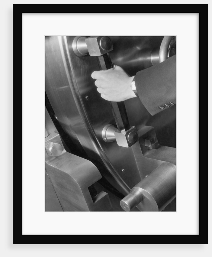 A Man Closes A Large Bank Vault by Anonymous