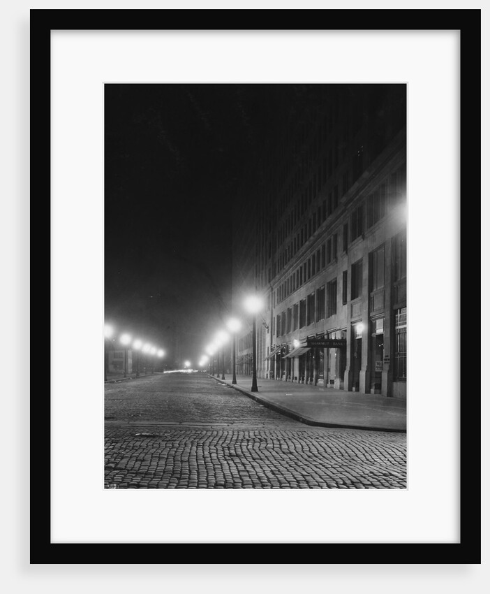 Street Lights Along a Cobblestone Street by Anonymous