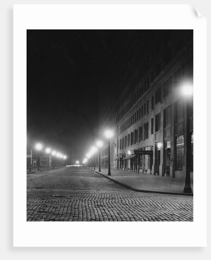 Street Lights Along a Cobblestone Street by Anonymous