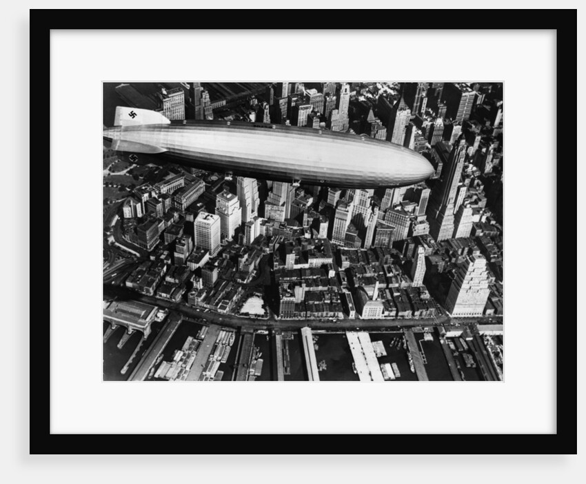 The German airship, the Hindenburg, above Manhattan, New York in 1936, on its way to its berth at Lakehurst , New Jersey, the same place where it inexplicably burst into flames the next year. by Anonymous