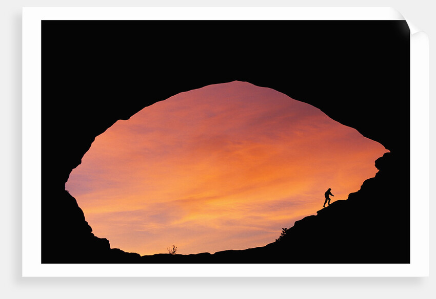 Hiker Climbing a Natural Arch in Utah by Anonymous