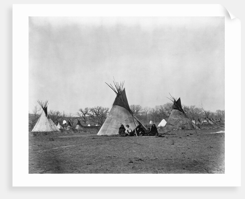 A Native American Family Sits Outside Their Teepee by Corbis