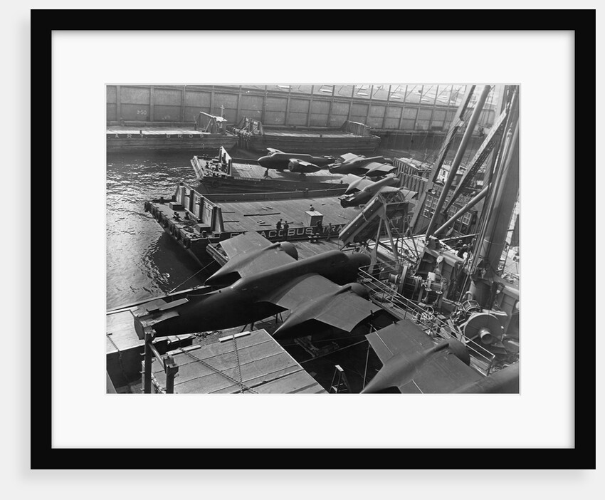 Heavy bombers on barges awaiting loading onto cargo vessel in New York harbor for shipment under provisions of the lend-lease by Anonymous