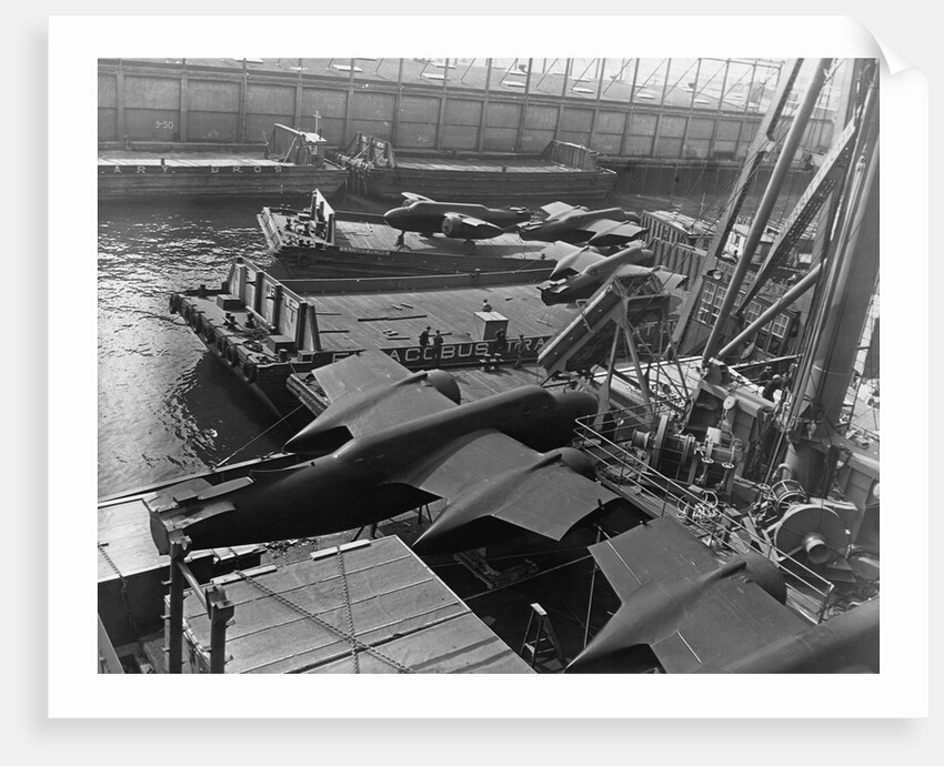 Heavy bombers on barges awaiting loading onto cargo vessel in New York harbor for shipment under provisions of the lend-lease by Anonymous