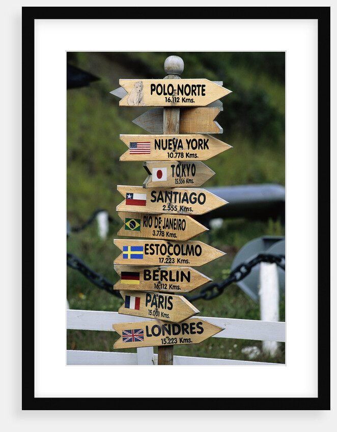 Mileage Sign Pointing Directions in Puerto Williams by Anonymous