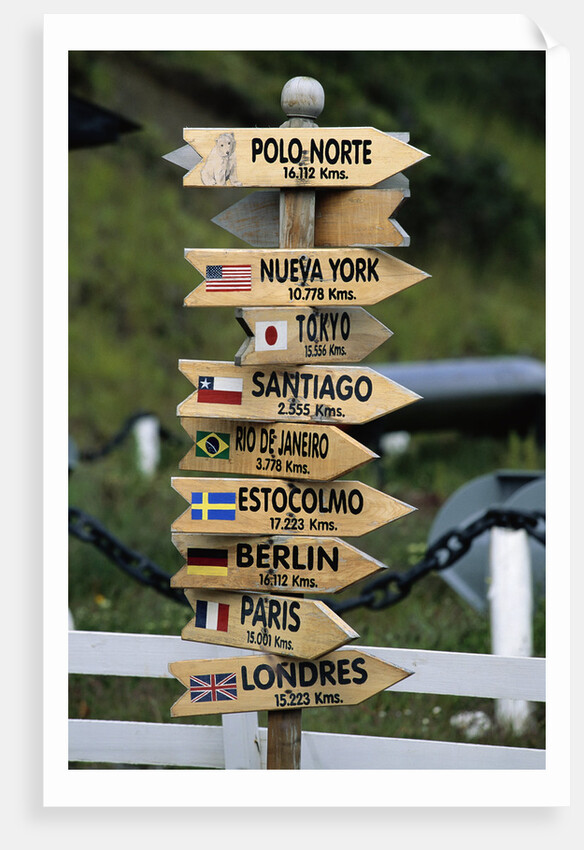 Mileage Sign Pointing Directions in Puerto Williams by Anonymous