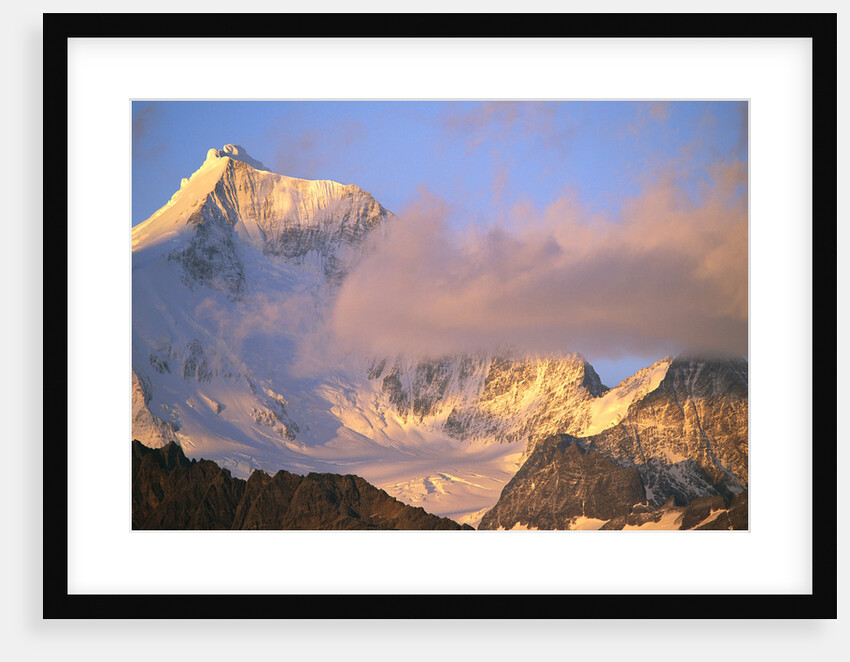 Cloud Floating by Glacier Covered Mountain Peak by Anonymous