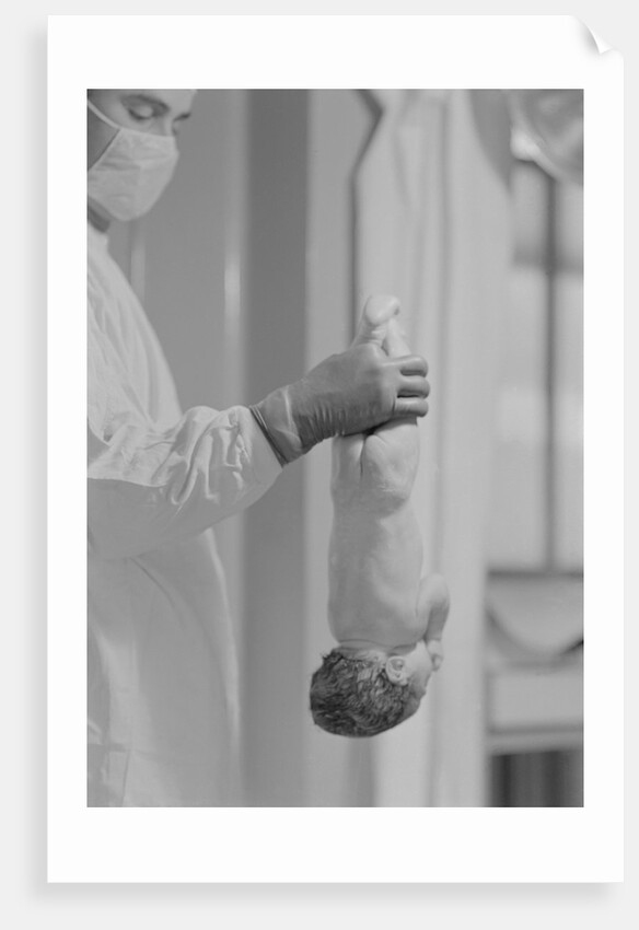 Doctor Holds New Born Baby by his Feet by Anonymous
