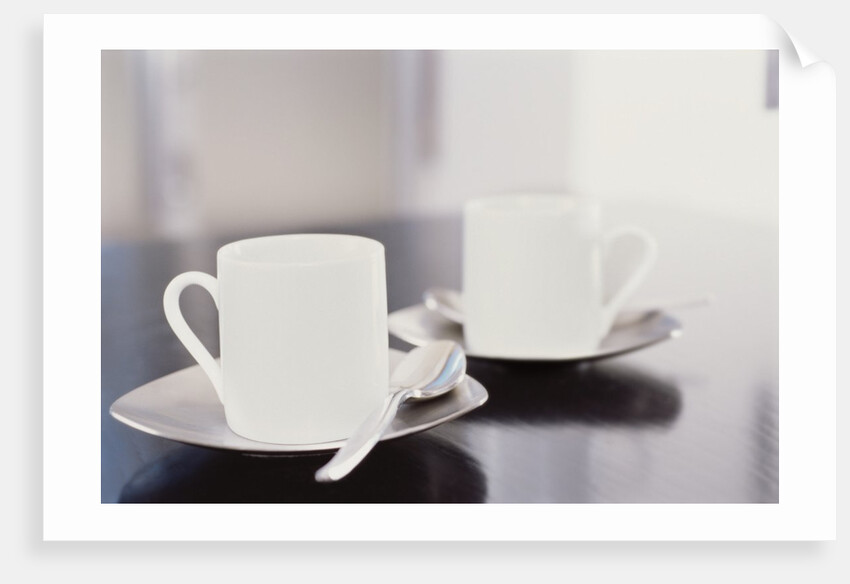 Two coffee cups on a table by Anonymous