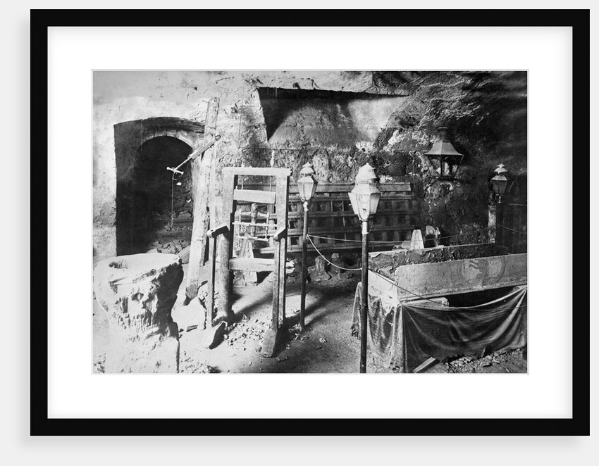 View of Torture Equipment in Cave Like Setting by Anonymous