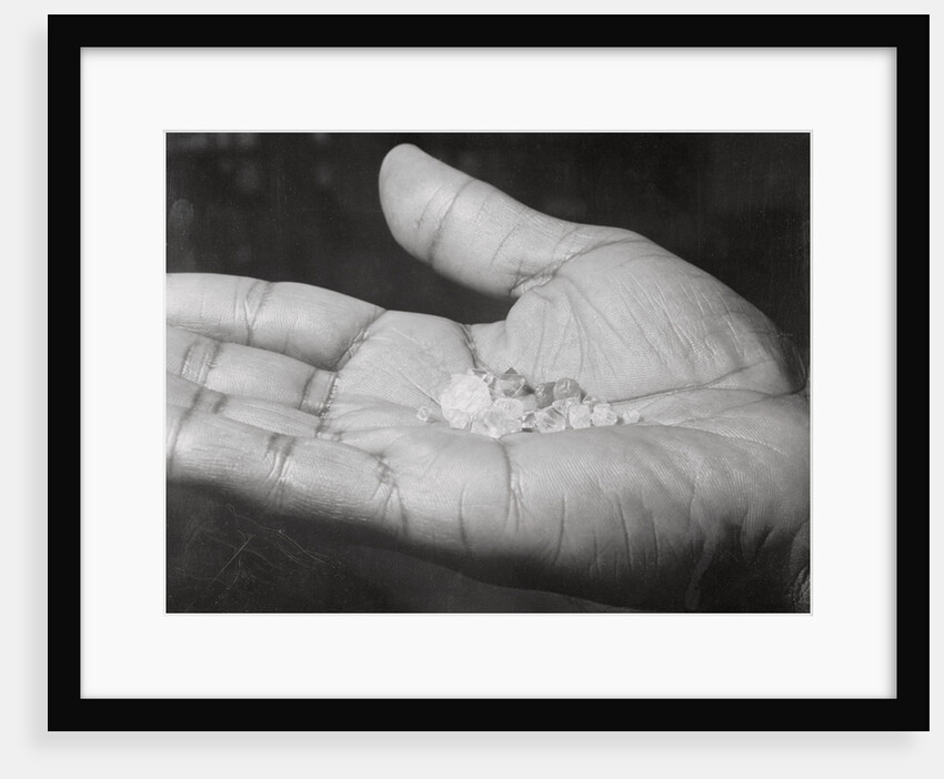Close up of Hand Holding Diamonds by Anonymous