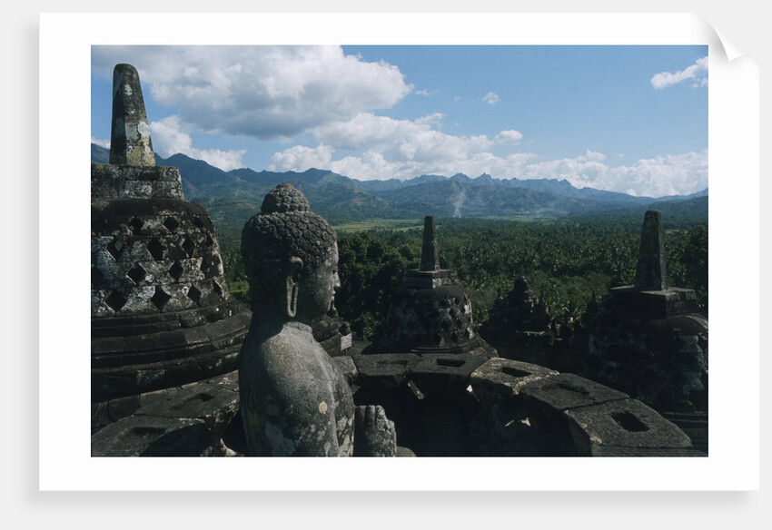 Statue of Buddha Sitting in a Stupa on Candi Borobudur by Anonymous