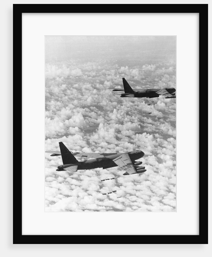 Military Airplane Dropping Bombs in Vietnam by Anonymous