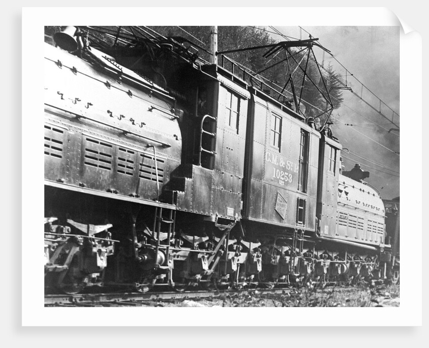 Steam Railroad Running Along Tracks by Anonymous