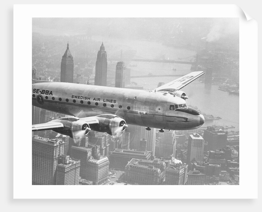 Aircraft Flying over City by Anonymous