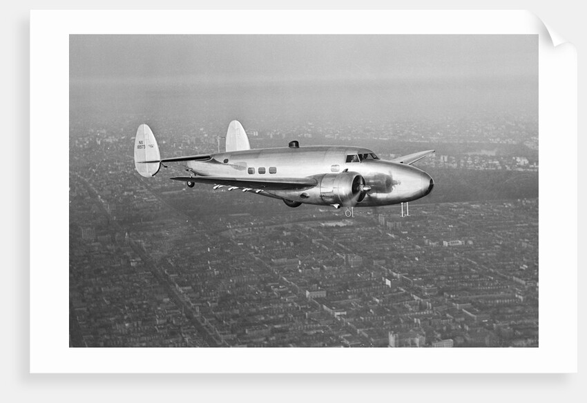Howard Hughes' Lockheed 14 Super Electra over New York City by Anonymous