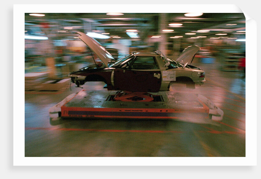 Partially Assembled Car Moving Through Work Station by Anonymous