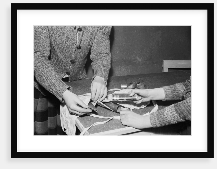Women Placing Metal Scraps Into a Brassiere by Anonymous